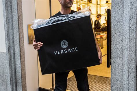 michael kors buys versace for 2.1 billion|michael kors acquisition.